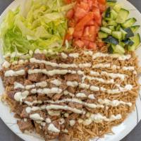 Lamb Over Rice Platter · A delicious meal of Lamb gyro  meat served on our fluffy aromatic Ahu Bara rice with salad i...