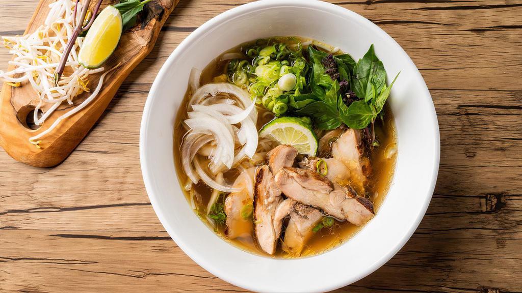 Chicken Pho Noodle Soup · Grilled chicken, with rice noodles, served with chicken broth soup, onions, scallions, and lemon, basil & bean sprouts on the side.