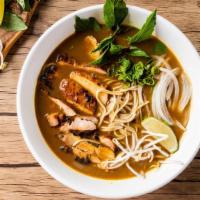 Curry Chicken Pho Noodle Soup · Grill chicken with rice noodles, served with curry flavor broth, onions, scallions, and lemo...