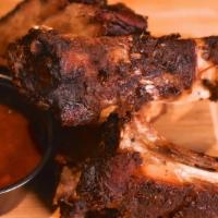 Jerk Ribs · smoked on a bed of spice berries + served with LoLo's bbq sauce
