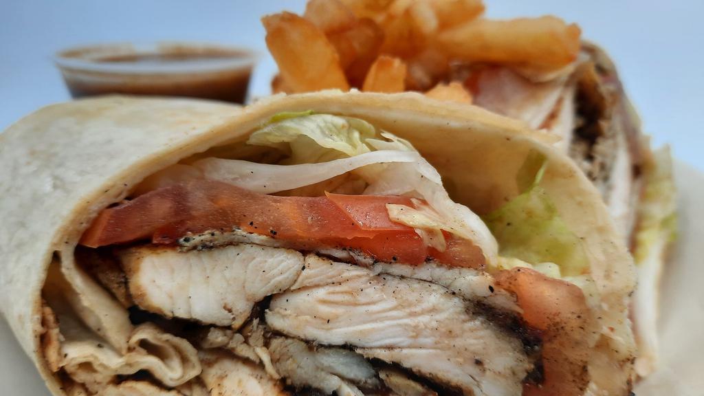 Jerk Chicken Wrap & Fries · A grilled tortilla loaded with sliced Jerk chicken breast, fresh lettuce, tomatoes, and our own savory Jerk sauce.
