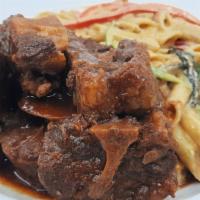 Oxtail · Served with your choice of Rasta pasta, rice & peas, mixed vegetables, mashed potatoes, or w...