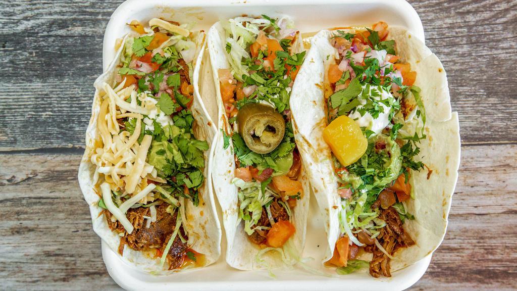 X-11. Rio Grande · 3 grande tacos (hard or soft shell: cheese, seasoned ground beef, beans, rice, guacamole, and peppers.