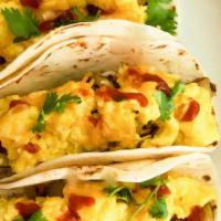 Breakfast Tacos · 3 soft corn tortilla, melted cheese, scrambled eggs, topped with pico de Gallo, served with ...
