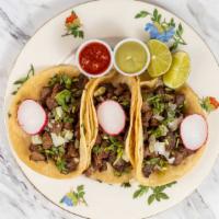 Mexican Tacos · Three tacos, served with chopped onions, cilantro, guacamole, spicy salsa on the side. Choic...