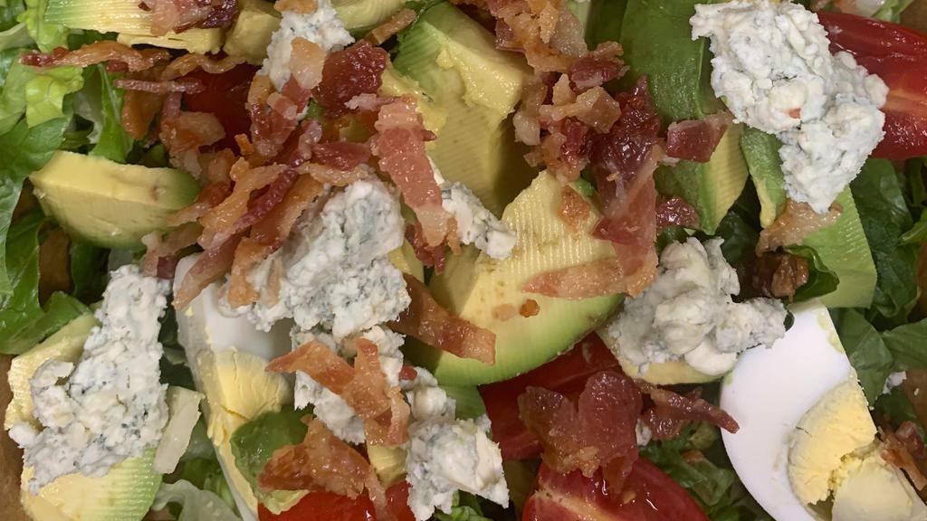 Cobb Salad · Avocado, tomatoes, hard-boiled egg, bacon and crumbled blue cheese served over Romaine lettuce with blue cheese dressing.