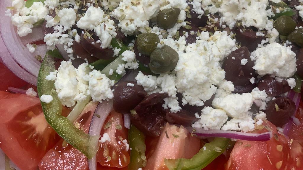 Village Greek Salad · Tomatoes,cucumber,onions,olives,green pepper,feta cheese,capers,oregano and olive oil.