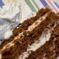 Carrot Cake · Homemade with Cream Cheese Icing served with Fresh Whipped Cream ( contains Walnuts)