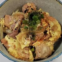 Chicken Donburi · Chicken and egg over rice with sautéed onions, negi, koma and nori flakes.