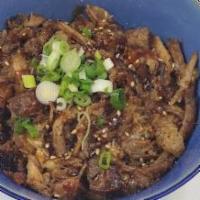 Beef Donburi · Thin-sliced and marinated rib-eye steak over rice with sauteed onion, negi and koma.