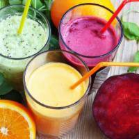 Tropical Hit Smoothie · Fresh smoothie made with pineapple, mango, papaya, kiwi, agave, and mango juice, with frozen...