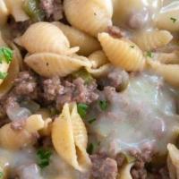 Butchers Mac · Shell pasta mixed w/ chef's special cheese blend, Grass fed New York strip steak and smoked ...