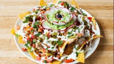 Nacho Mama'S · Tortilla chips topped with your meat choice, vegetarian options available, homemade beans, lettuce, cheese mix, jalapenos, Cotija cheese, sour cream and pico de gallo.
