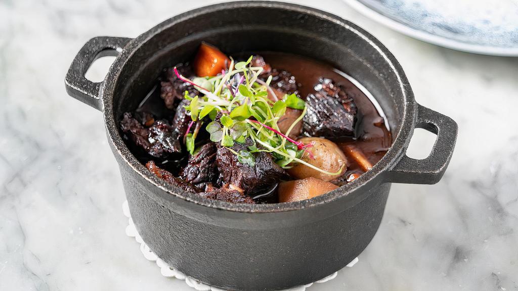 Bœuf Bourguignon · Braised Black Angus beef stew in a red wine aromatic sauce, carrots, steamed potatoes, button mushrooms, pearl onions.