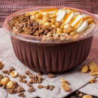 Peanut Butter Cup Acai Bowl · Organic coconut milk, organic acai, organic peanut butter, banana, organic cacao
Topped with...