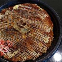 Okonomiyaki · Japanese savory pancakes. Cabbage, egg, tempura flakes, ginger, flour.