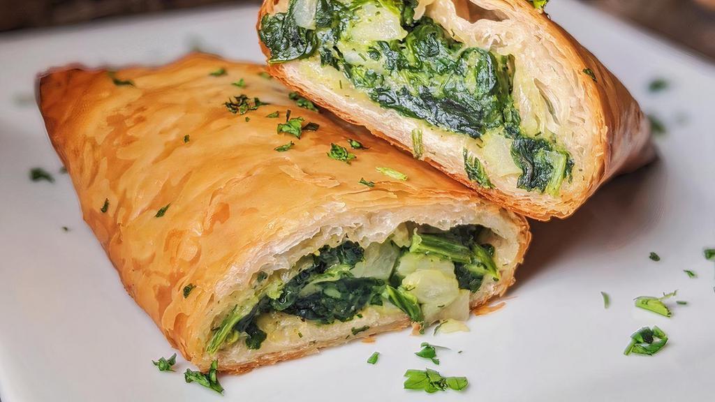 Spanakopita · Layers of crisp phyllo dough filled with fresh spinach and feta cheese.