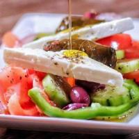 Village Salad · Barrel-aged feta, fresh tomatoes, cucumbers, bell peppers, shaved red onions, imported olive...