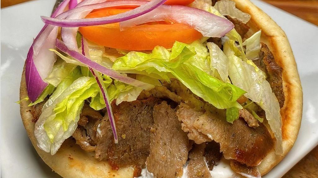 Gyro Sandwich · Seasoned beef and lamb, slow-roasted and carved off the rotisserie, wrapped in warm pita bread.