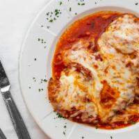 Chicken Parmigiana · Breaded and fried, with tomato sauce, and melted mozzarella