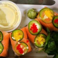 Salmon Lover · Inside: Crunchy spicy salmon, mango. Outside: salmon, red caviar with yuzu sauce, sweet miso...