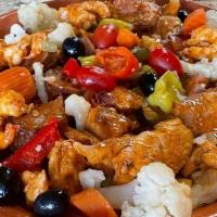 Chicken Picadinho · cubed chicken mix sauteed with sausage onions and peppers over square fried potato in a brow...
