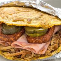 Cubano Patacon · Smashed plantain sandwich stuffed with pulled roasted pork, ham, fried queso blanco, half so...