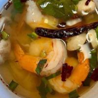 Tom Yum Shrimp Soup / Tom Yum Goong · Soup made with kaffir lime leaves, lemongrass, galanga, shallots, tomatoes, cilantro, scalli...