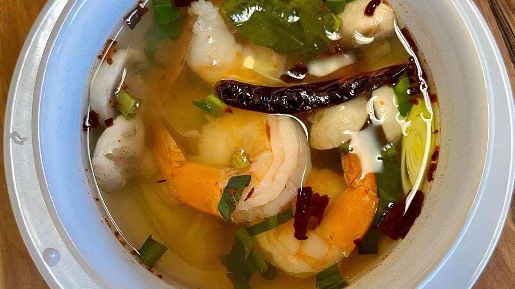 Tom Yum Shrimp Soup / Tom Yum Goong · Soup made with kaffir lime leaves, lemongrass, galanga, shallots, tomatoes, cilantro, scallions, culantro, and lime juice.