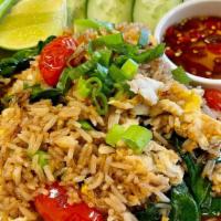 House Fried Rice / Khao Pad · Fried rice with tomatoes, eggs, garlic, Chinese broccoli,
topped with scallions and your cho...