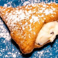 Stuffed Zeppoles (3 Pieces) · Zeppoles stuffed with cannoli cream topped with powdered sugar.