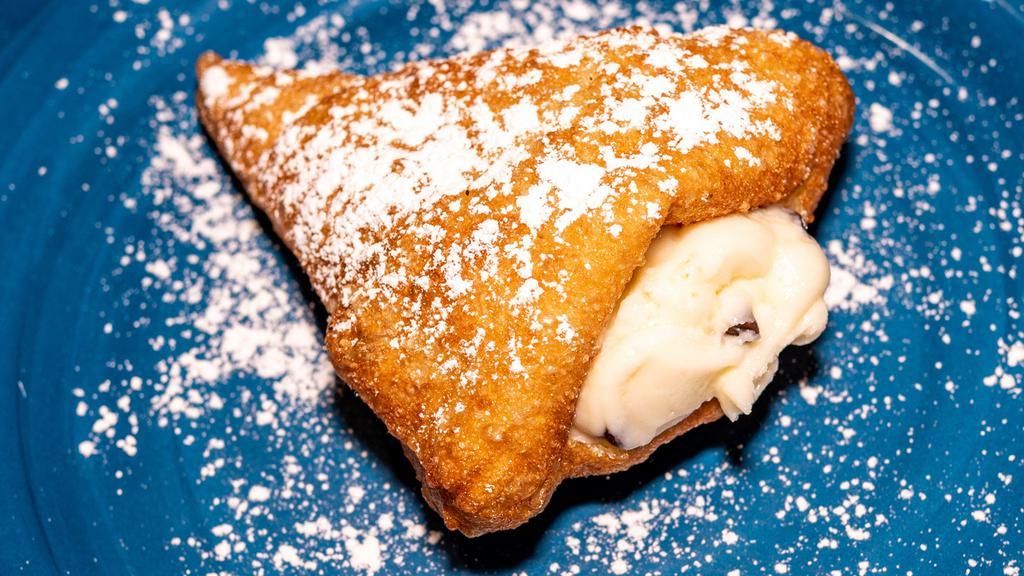 Stuffed Zeppoles (3 Pieces) · Zeppoles stuffed with cannoli cream topped with powdered sugar.