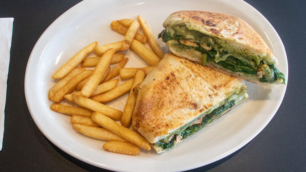 Pesto Panini · Grilled chicken, spinach tomatoes, provolone cheese, and pesto sauce. Served with french fries.