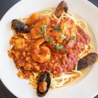 Seafood Marinara · With shrimp, scallops, clams, mussels & calamari in a
garlic basil wine sauce. Served with a...