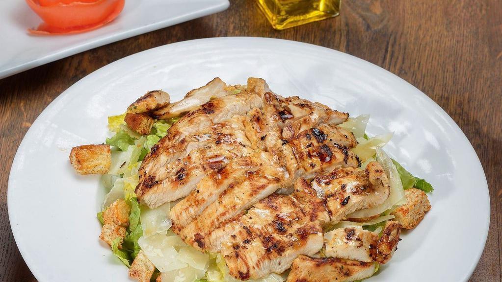 Chicken Caesar Salad · Marinated grilled chicken, romaine lettuce, croutons, shaved Parmesan, and Caesar dressing.