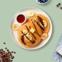 Nutty Banana Pancakes · 3 Butter Milk Pancakes with walnuts and bananas.