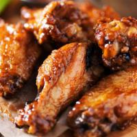 Bbq Wings · Five fresh buffalo wings smothered in savory BBQ sauce and served with creamy Bleu cheese di...