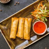 Coconut Shrimp Spring Rolls · Three pieces. Golden crispy spring roll filled with fresh-caught prawns and traditional vege...