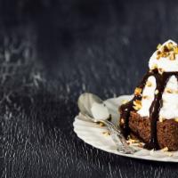 Brownie All The Way · Hot fudge brownie, topped with Häagen-Dazs ice cream, chopped nuts, and whipped cream.