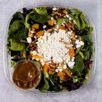 Goat Cheese Salad · Mixed mesclun greens, walnuts, goat cheese, dried apricots, cranberries and our own homemade...