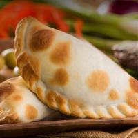 Ground Beef Empanada · Argentina meets America with a blend of red peppers, scallions, potatoes, green olives, and ...