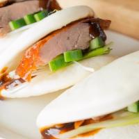 Peking Duck Bun · Roasted duck, cucumber, scallion, hoisin sauce with three steamed bun.