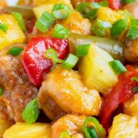 Pineapple Chicken · Lightly fried white meat chicken with pineapple, red pepper, green pepper and sweet peas in ...