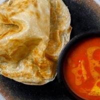 Crispy Roti · Crispy fluffy Indian bread served with a curry dipping sauce.
