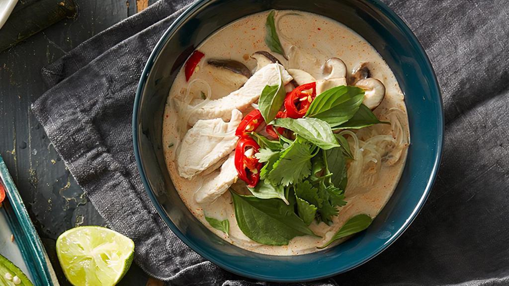Tom Kha Noodle Soup · Rich, creamy, tangy, and spicy. Spicy coconut broth made with choice of noodles, onions, red peppers, tomatoes, mushroom, and thai basil.