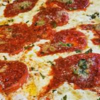 Sicilian Pizza · Thin crust pizza with tomato sauce, mozzarella and basil.
