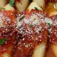 Stuffed Shells · A DELICIOUS DISH OF SHELLS STUFFED W/RICOTTA CHEESE & SMOTHERED W/OUR HOMEMADE ZESTY MARINAR...