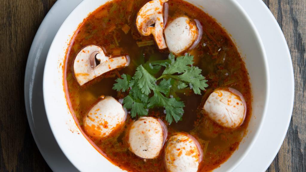 Tom Yum Soup · A savory spicy and sour soup seasoned with exotic Thai herbs, mushrooms, lemongrass kaffir lime leaves and cilantro. Spicy.