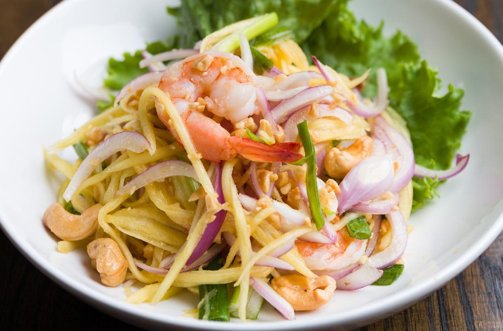 Mango Salad With Shrimp · Shredded mango, steamed shrimp, lettuce, tomatoes, cashew nut, onion and scallion with special homemade lime juice dressing. Spicy.