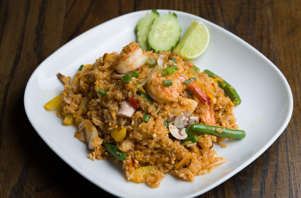 Tom Yum Fried Rice · Steamed Jasmin rice, kaffir lime leaves, mushroom, onion, lime juice and chili paste. Spicy.